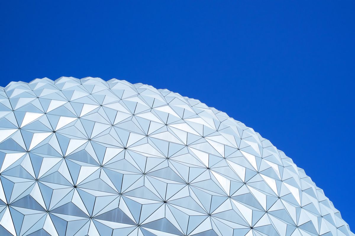 A photo of part of Spaceship Earth at Epcot, Walt Disney World, against a blue sky