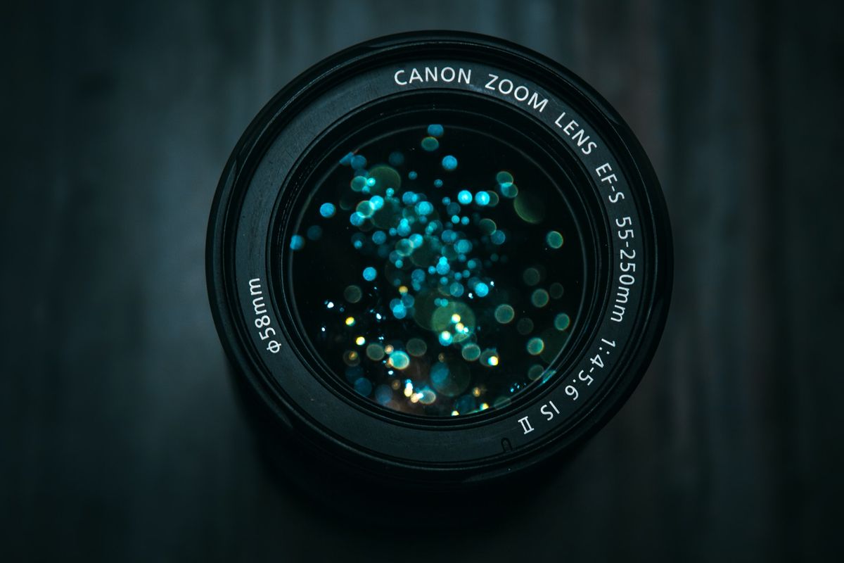 A photo of a camera lens with multiple light reflections in the glass