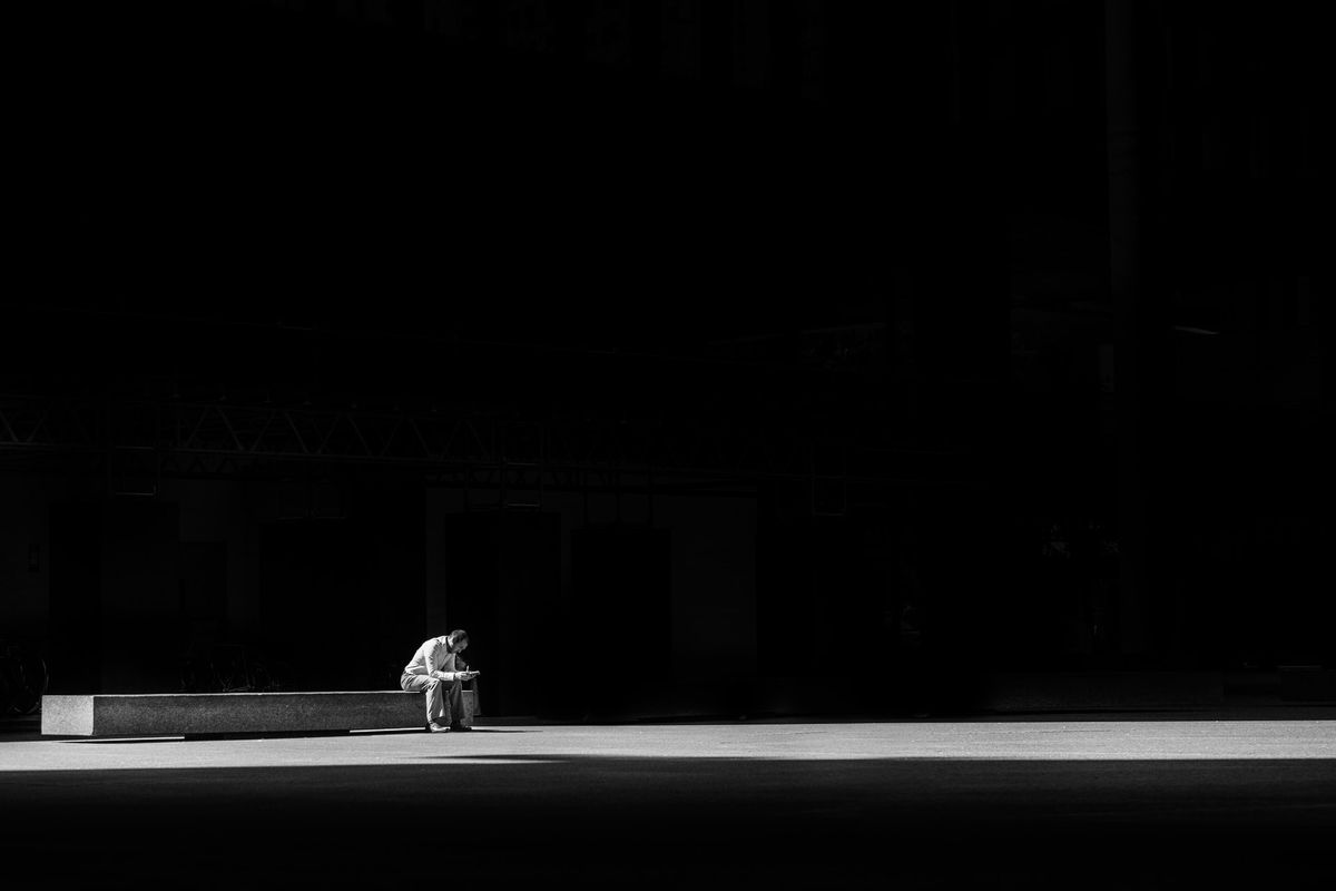 A black and white photo of a man thinking