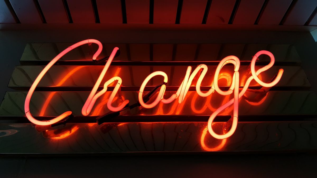 A neon light of the word "Change"