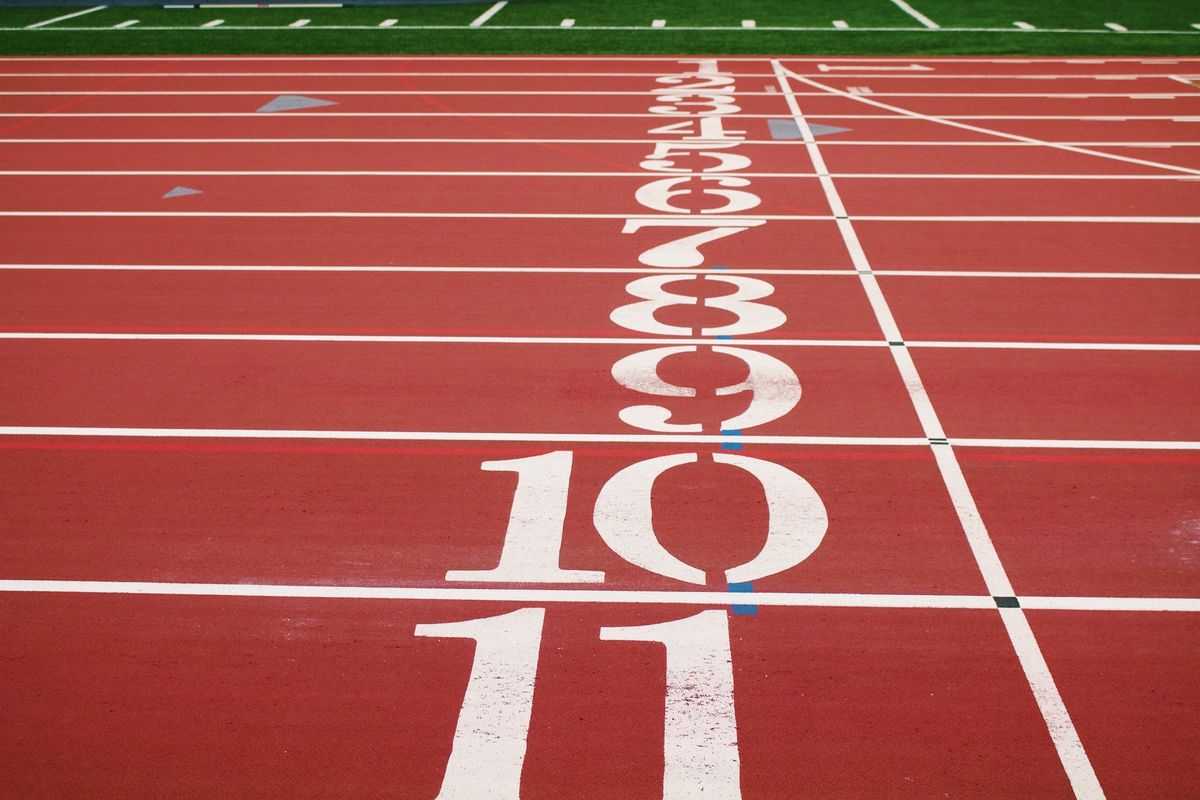 A photo of a track with eleven starting lane numbers